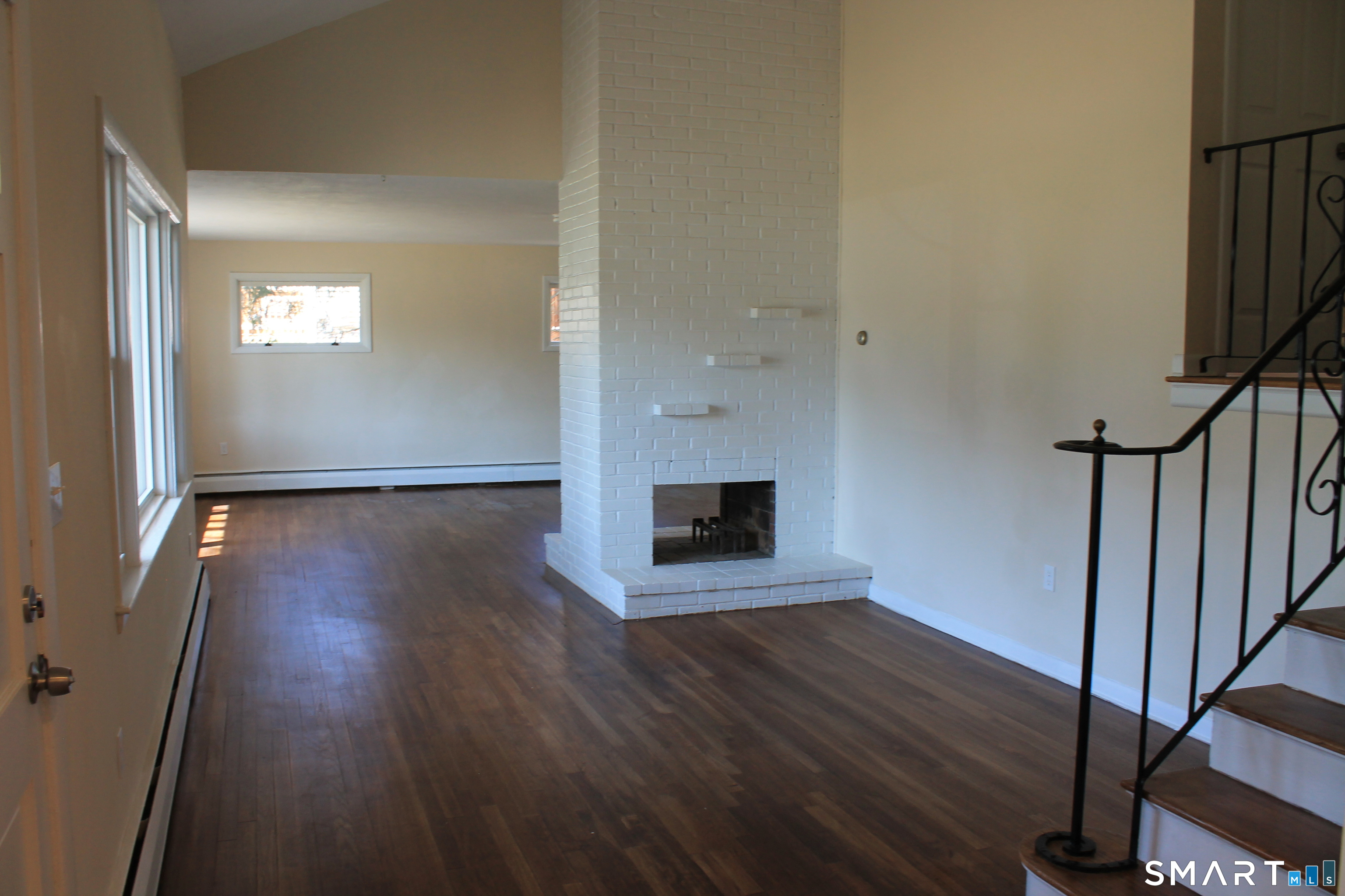 134 Sunset Street Windsor Locks, CT 06096 - Photo 15 of 23 a view of an empty room with wooden floor and a window