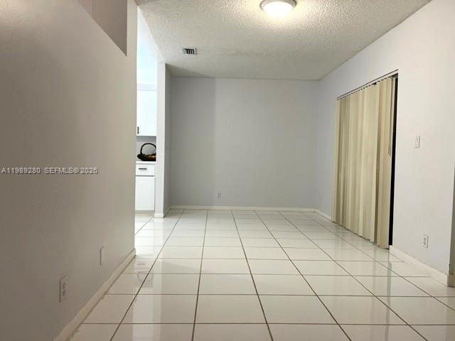 543 Racquet Club Road, Unit 33 Weston, FL 33326 - Photo 10 of 28 an empty room with white walls and tiles