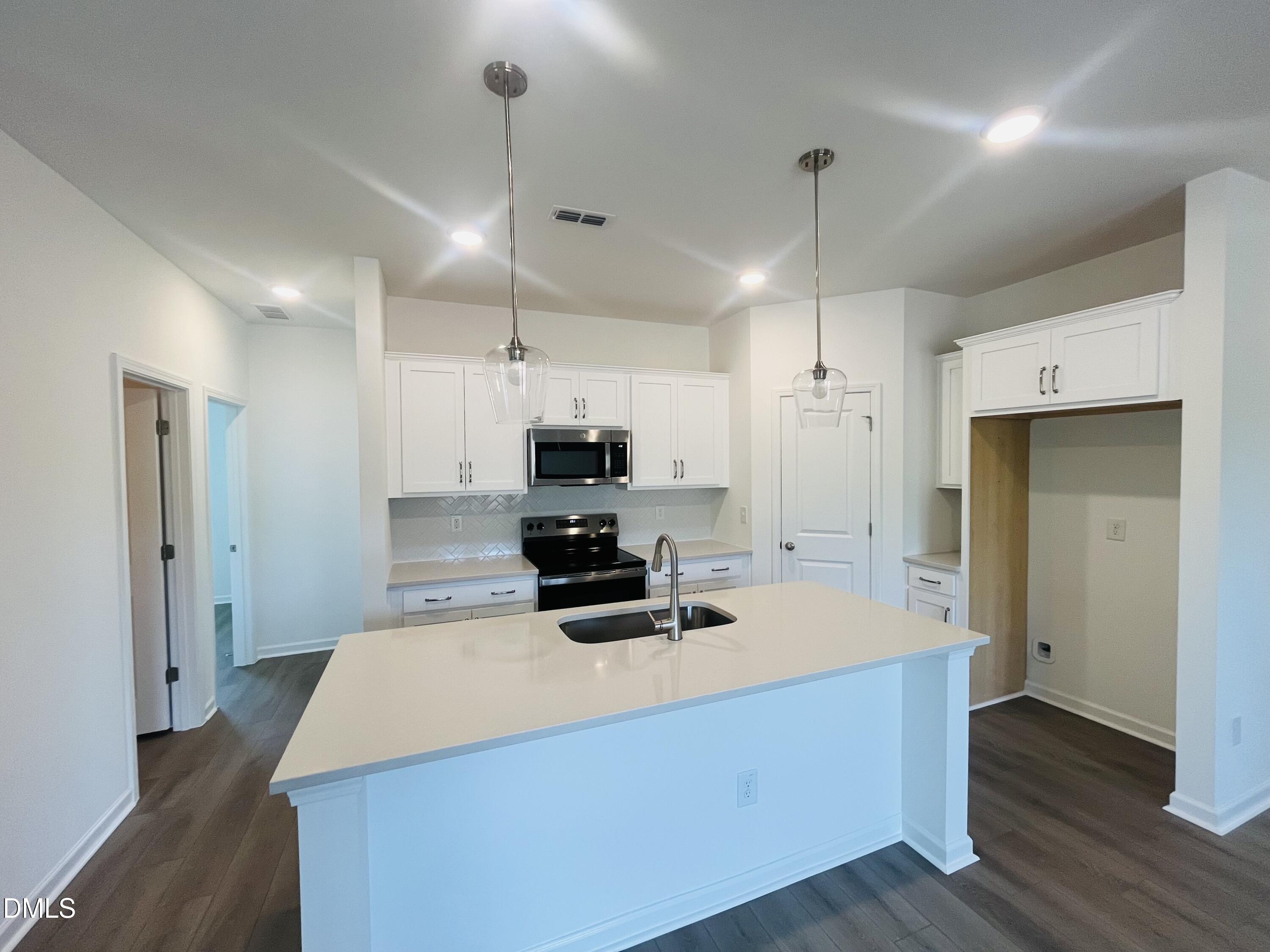 11487 Salers Loop Middlesex, NC 27557 - Photo 16 of 31 a kitchen with kitchen island a sink stainless steel appliances and cabinets