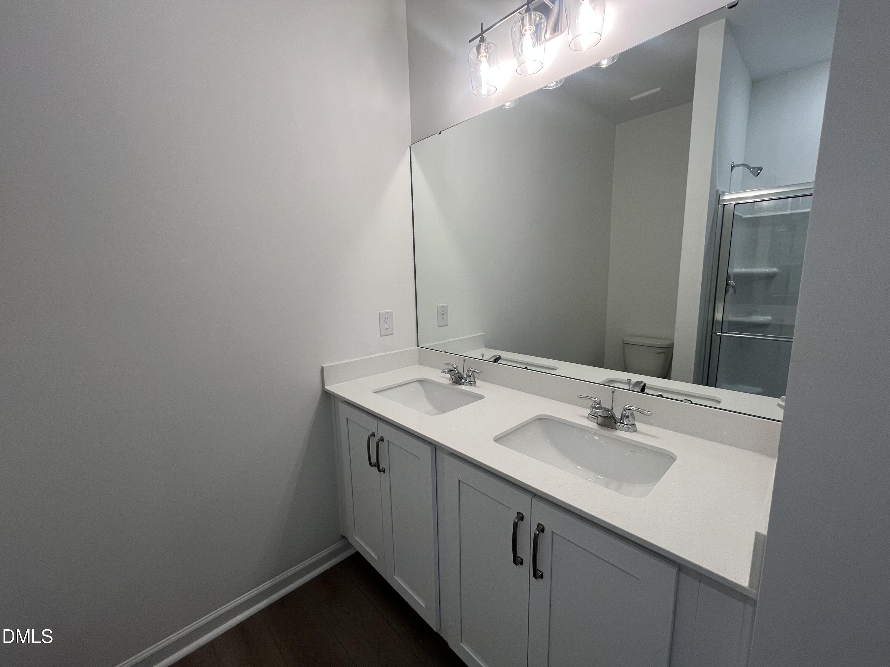 11487 Salers Loop Middlesex, NC 27557 - Photo 22 of 31 a bathroom with a sink and a mirror