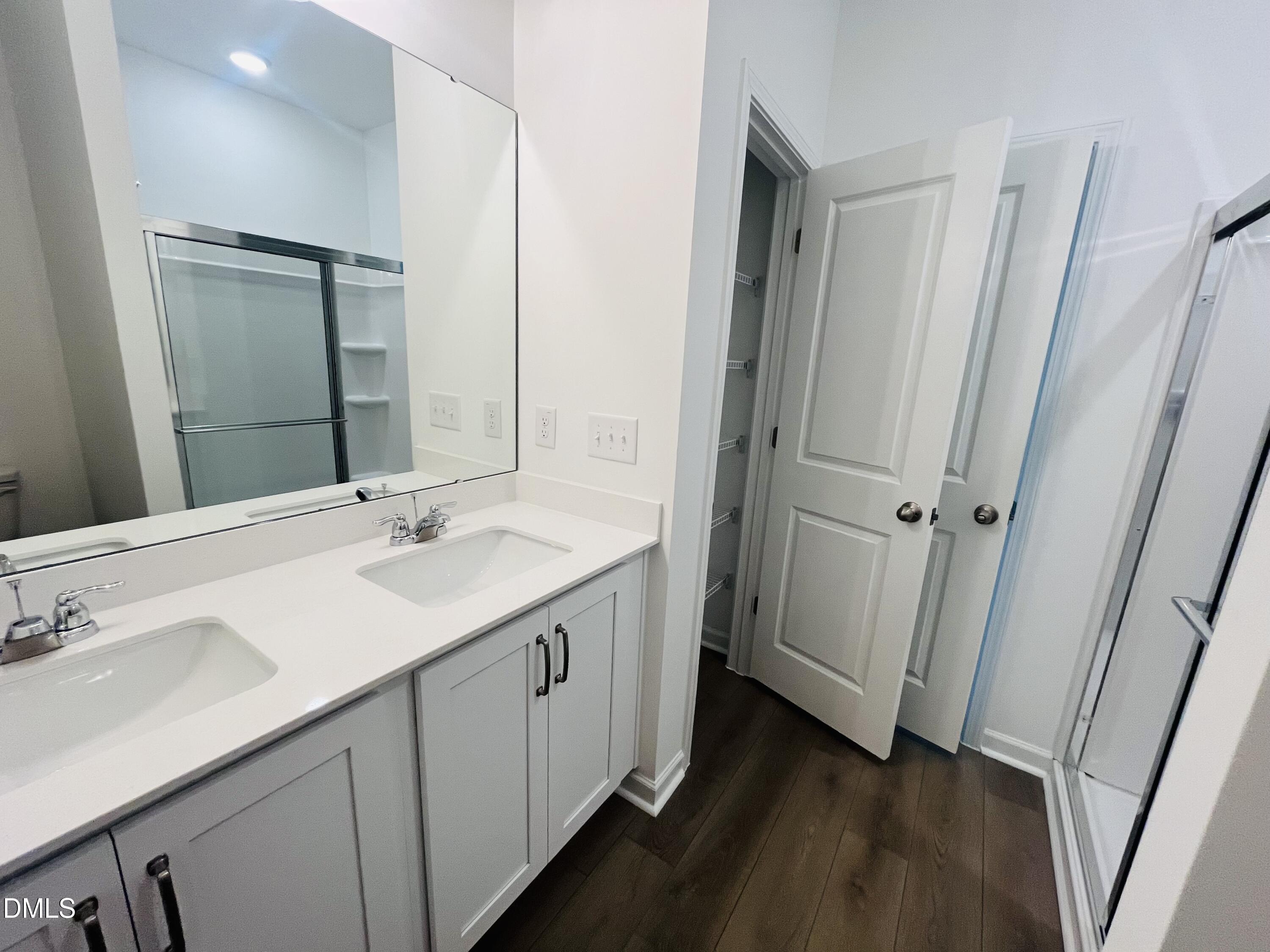 11487 Salers Loop Middlesex, NC 27557 - Photo 23 of 31 a bathroom with a double vanity sink and mirror