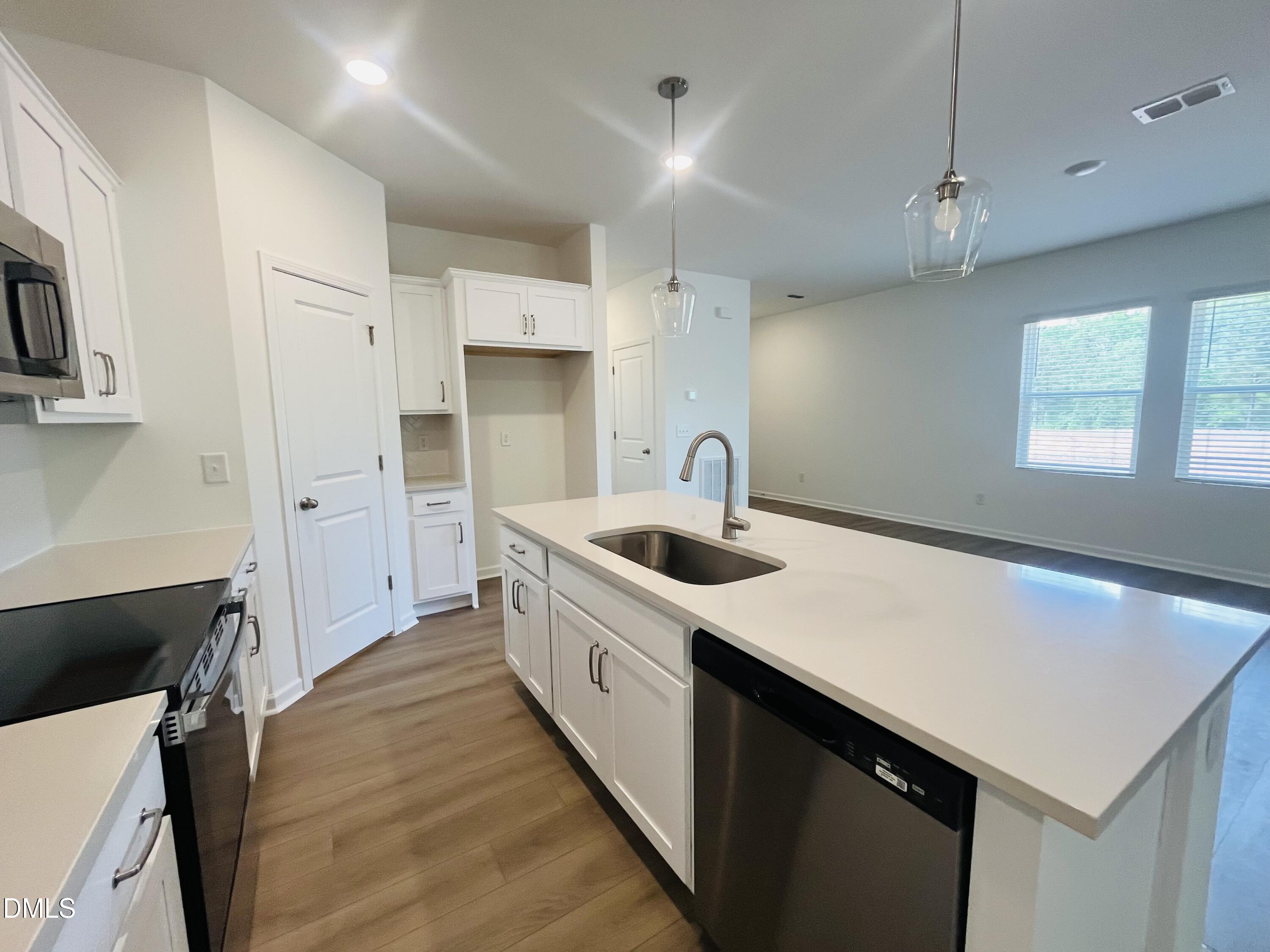 11487 Salers Loop Middlesex, NC 27557 - Photo 27 of 31 a kitchen with a sink a stove and cabinets