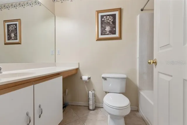 a white toilet sitting next to a bathroom sink