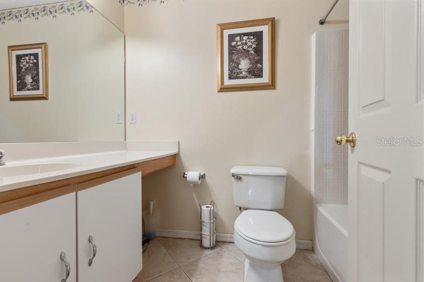 11251 Pickford Street Spring Hill, FL 34609 - Photo 16 of 29 a white toilet sitting next to a bathroom sink