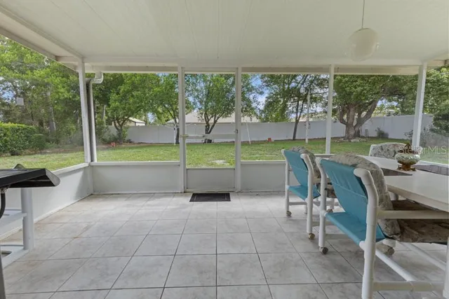 a view of a dining room with furniture and a backyard