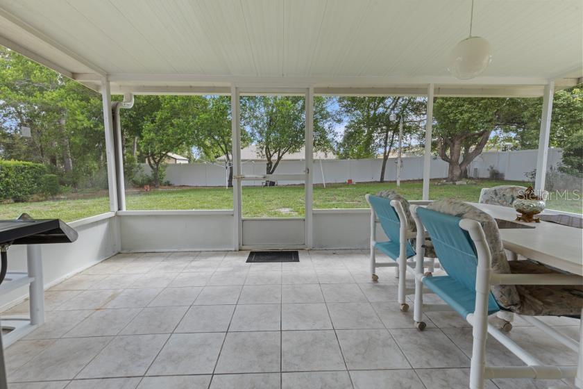 11251 Pickford Street Spring Hill, FL 34609 - Photo 19 of 29 a view of a dining room with furniture and a backyard