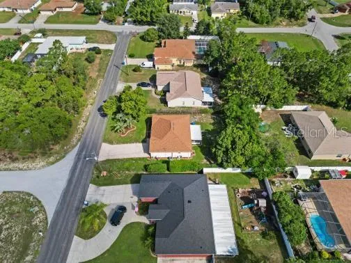 an aerial view of residential house with outdoor space and street view
