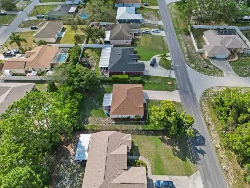 an aerial view of multiple houses with yard