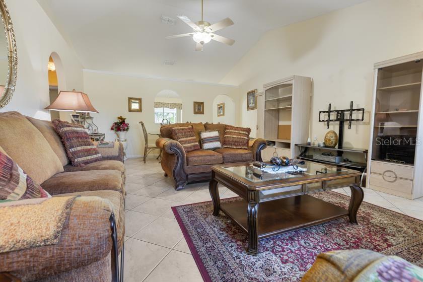 11251 Pickford Street Spring Hill, FL 34609 - Photo 4 of 29 a living room with furniture and a chandelier
