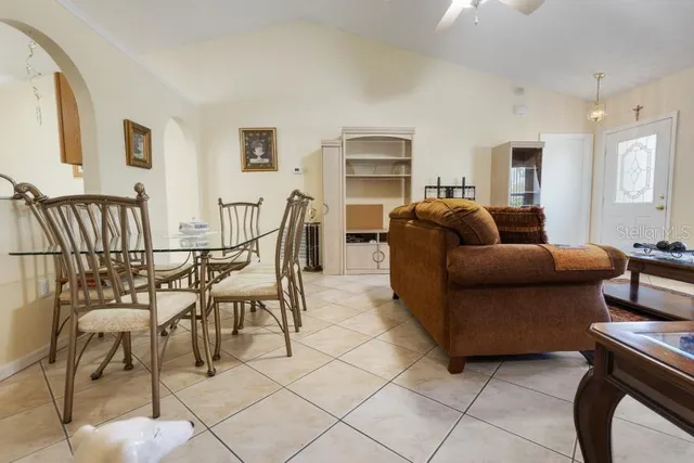 a living room with furniture and a dining table