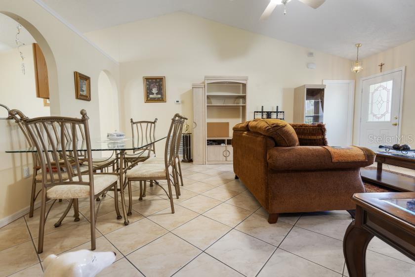 11251 Pickford Street Spring Hill, FL 34609 - Photo 5 of 29 a living room with furniture and a dining table