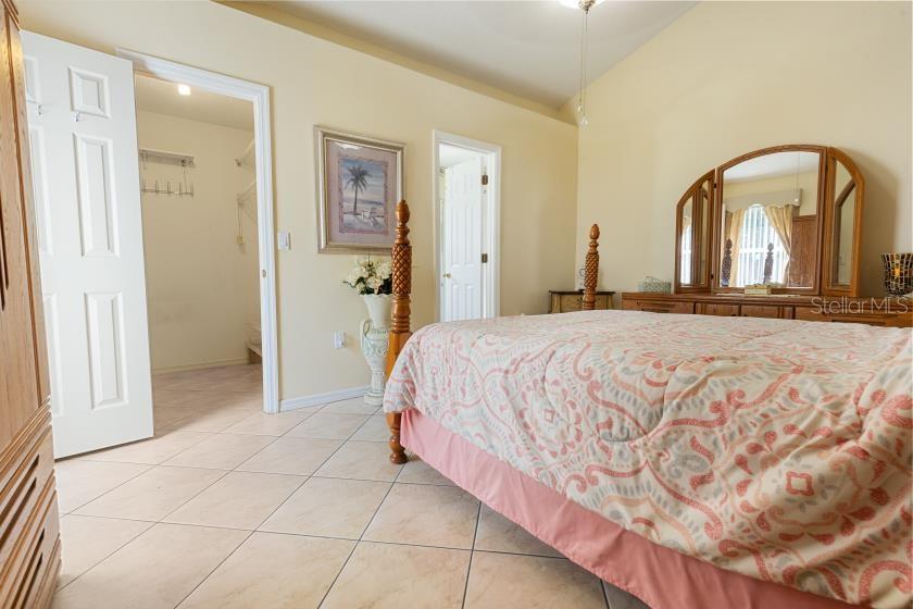 11251 Pickford Street Spring Hill, FL 34609 - Photo 9 of 29 a bedroom with a bed and a bathroom