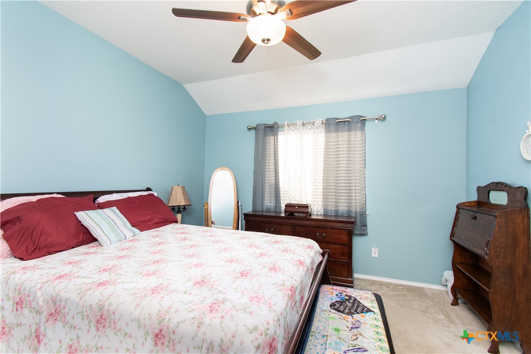 7916 Honeysuckle Temple, TX 76502 - Photo 13 of 20 a bedroom with a bed and a chandelier