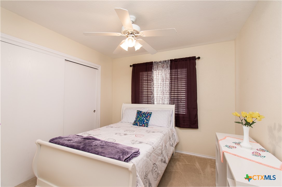 7916 Honeysuckle Temple, TX 76502 - Photo 15 of 20 a bedroom with a bed and a chandelier