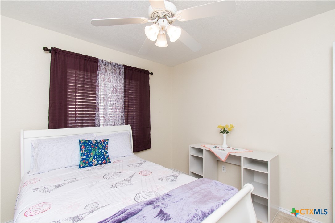 7916 Honeysuckle Temple, TX 76502 - Photo 16 of 20 a bedroom with a bed and a chandelier