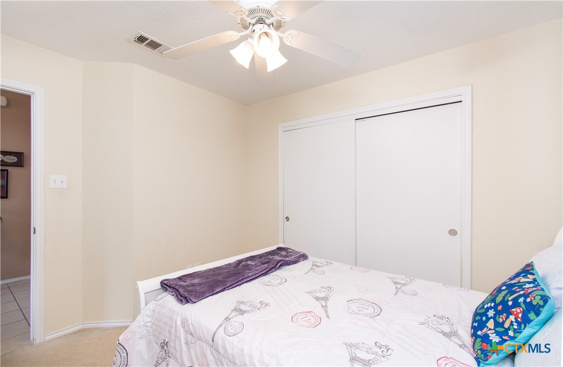 7916 Honeysuckle Temple, TX 76502 - Photo 17 of 20 a bedroom with a bed and a chandelier