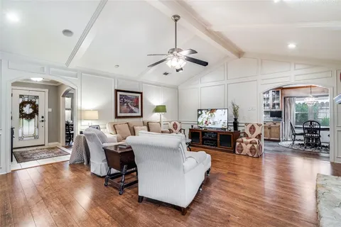 a living room with furniture fireplace and wooden floor