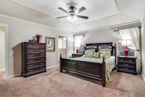 a bed room with a bed and a ceiling fan