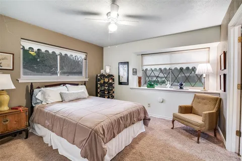 a bedroom with a large bed and a couch