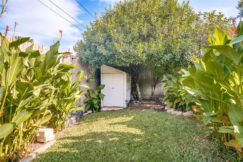 a view of a garage with a tree