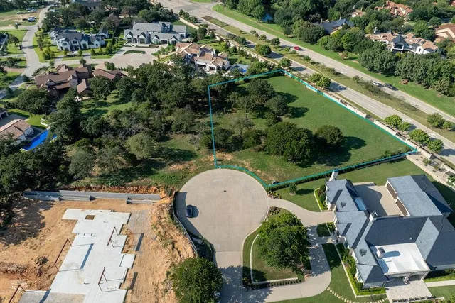 an aerial view of a house with outdoor space and street view