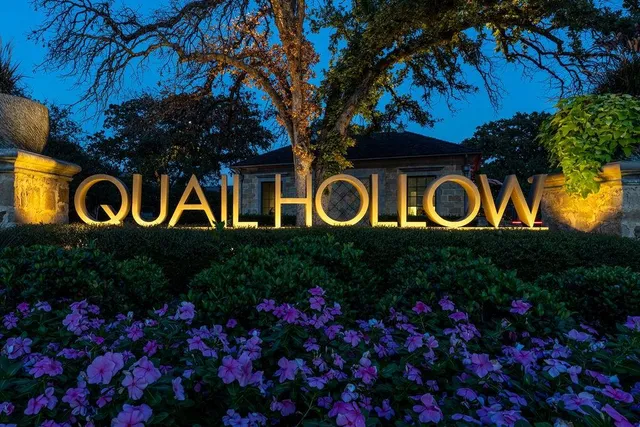 a sign that is sitting in front of flowers