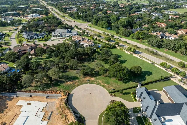 an aerial view of a house with a yard and outdoor seating