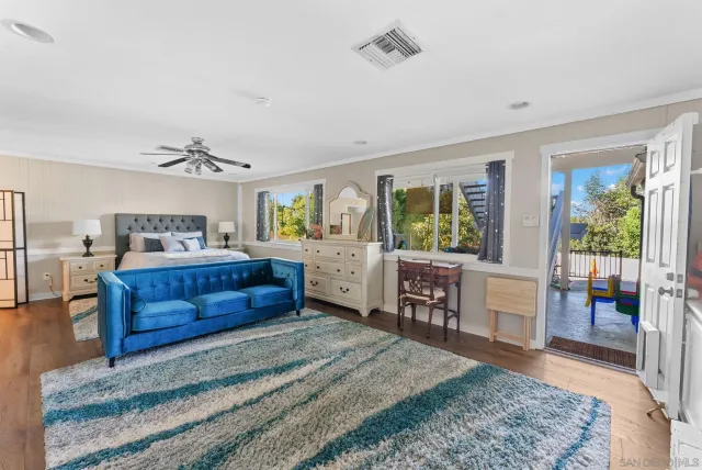 an aerial view of residential houses with outdoor space and trees