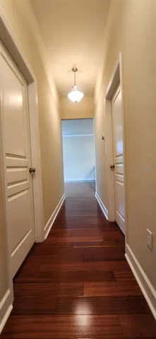 a view of a hallway with wooden floor