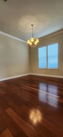 a view of a room with wooden floor and large window