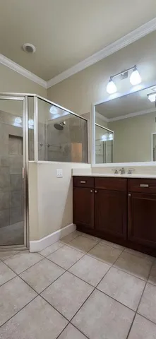a spacious bathroom with a granite countertop sink a mirror and a bathtub