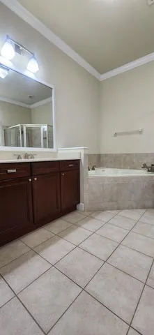 a spacious bathroom with a bathtub and a sink