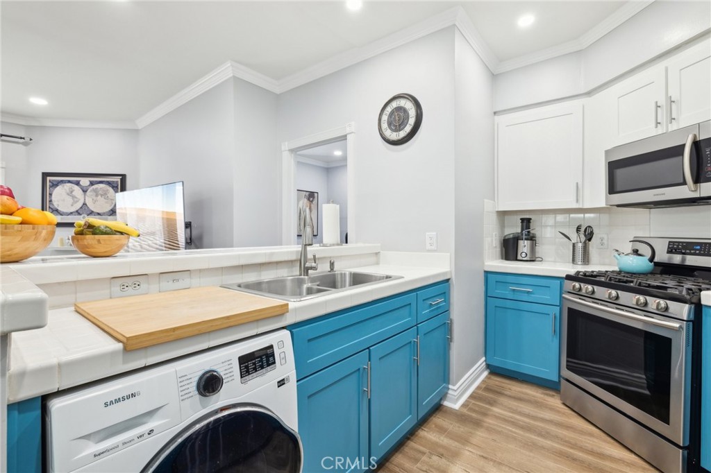 14914 Hamlin Street, Unit 104 Van Nuys, CA 91411 - Photo 3 of 10 a kitchen with a stove and a sink