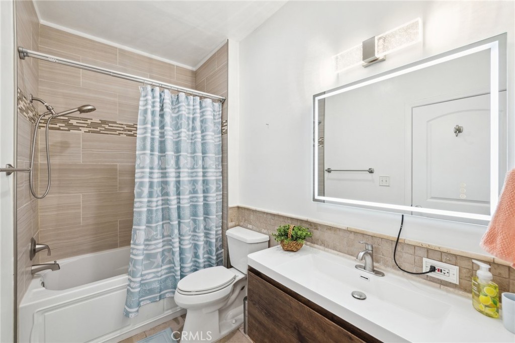 14914 Hamlin Street, Unit 104 Van Nuys, CA 91411 - Photo 6 of 10 a bathroom with a sink toilet and shower