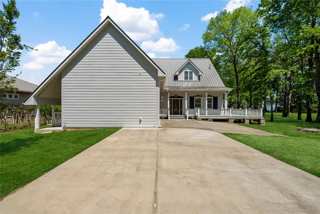 a front view of a house with yard and green space