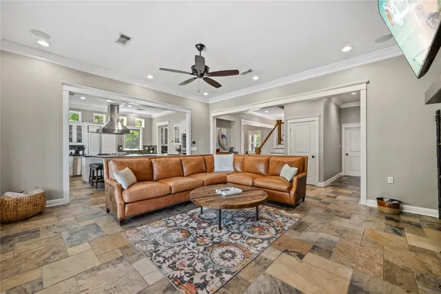 a living room with furniture a fireplace and a flat screen tv
