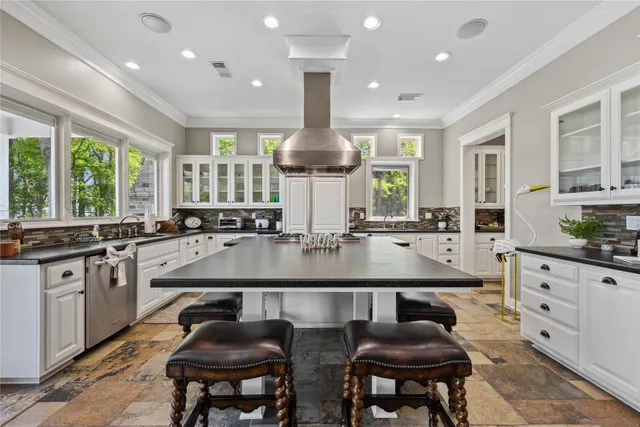 a kitchen with stainless steel appliances granite countertop a stove a sink and a refrigerator