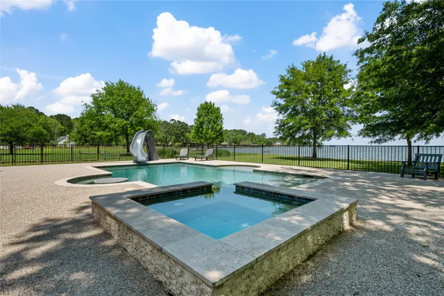 a view of a backyard with swimming pool