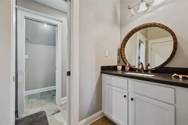 a bathroom with a glass shower door