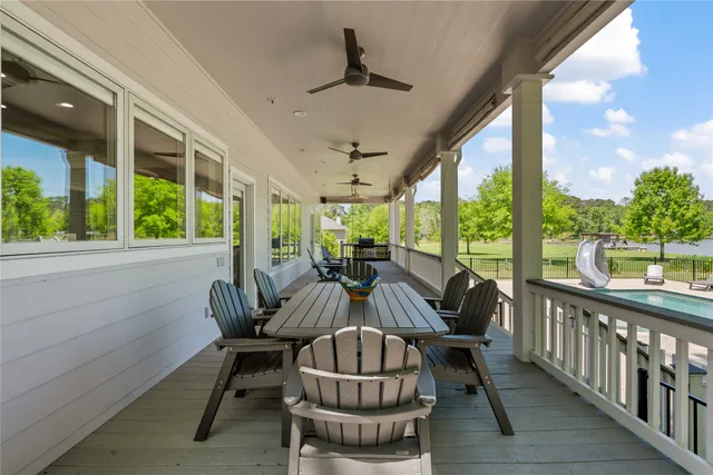 a view of house with outdoor seating and a forest