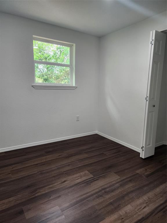 1133 Highway 2861 Comanche, TX 76442 - Photo 11 of 15 a view of an empty room with wooden floor and a window