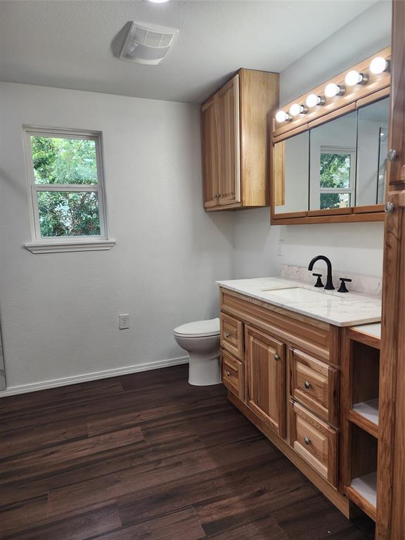 1133 Highway 2861 Comanche, TX 76442 - Photo 8 of 15 a spacious bathroom with a toilet sink and mirror