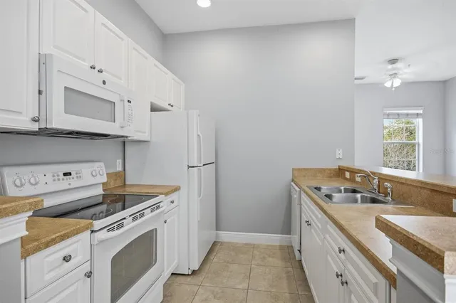 a kitchen with a sink stove top oven and microwave