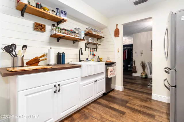 a kitchen with a refrigerator and cabinets