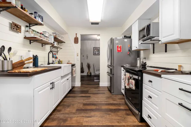 a kitchen with stainless steel appliances granite countertop a sink and cabinets