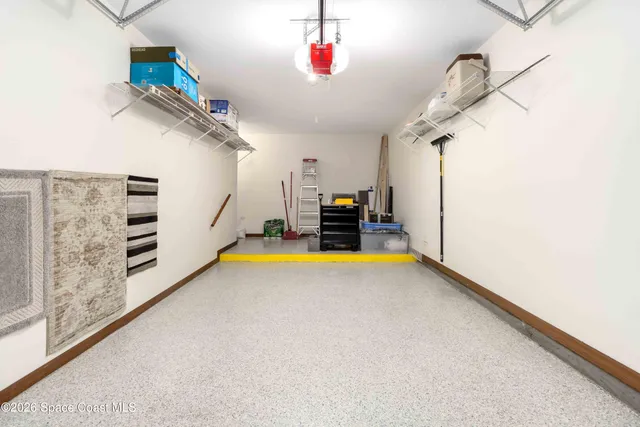 a bathroom with a tub and a view of living room