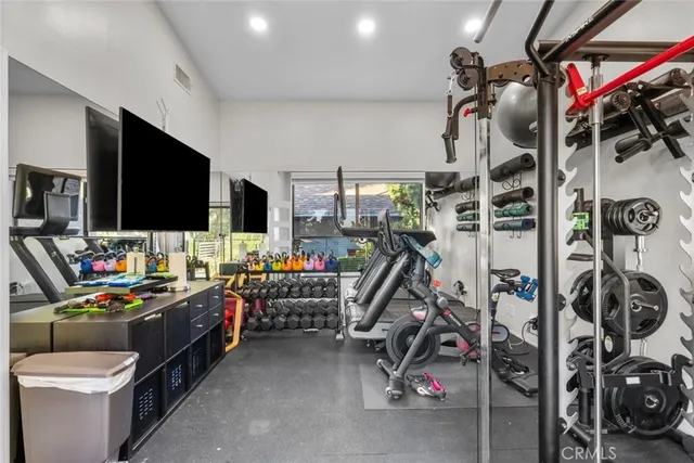 a large bed sitting in a bedroom next to a window