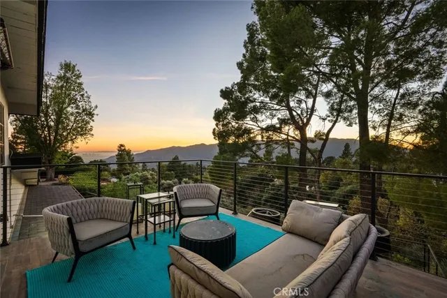 a view of a living room with a large window and wooden floor