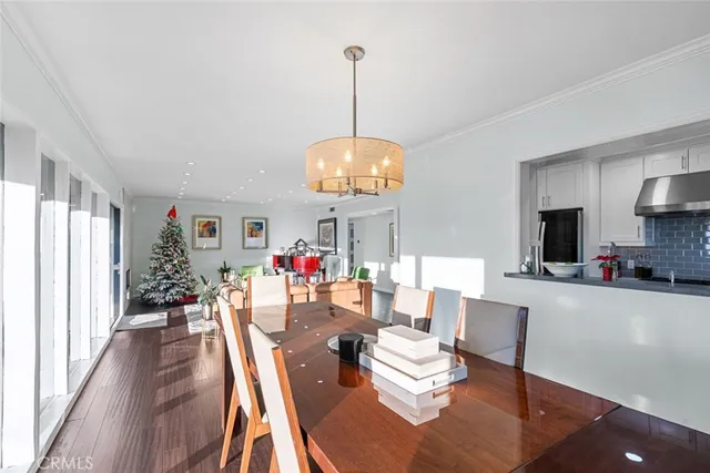 a view of a dining room with furniture wooden floor and chandelier