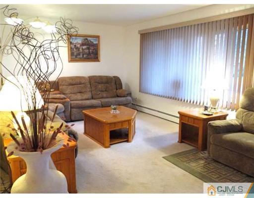 83 Stony Road Edison, NJ 08817 - Photo 2 of 11 a living room with furniture and a fireplace